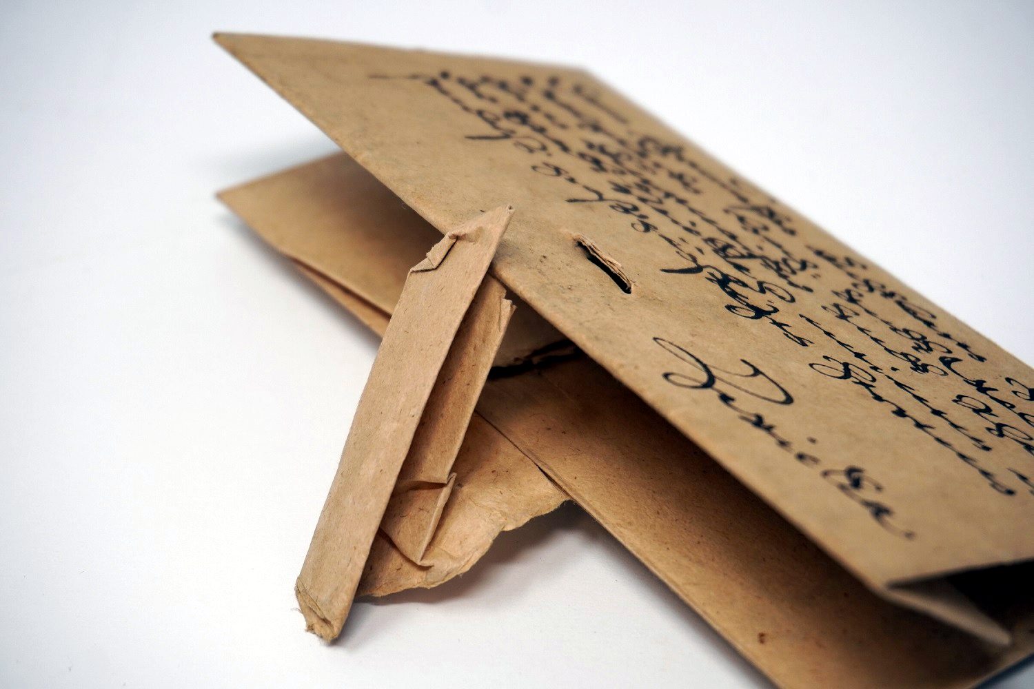 A folded paper letter from 1603, with a narrow paper strip threaded through slits to lock it shut